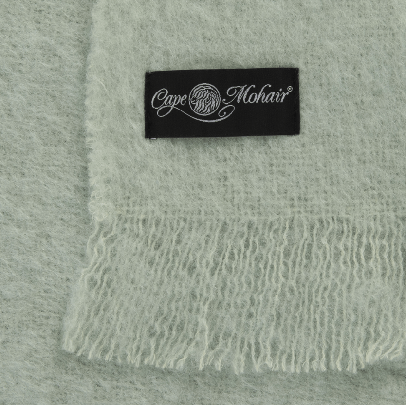 Close up of pastel green mohair blanket