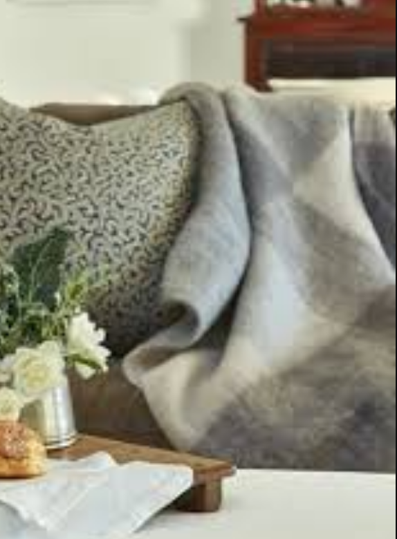 Ingubo Pebble Beach blanket on a sofa
